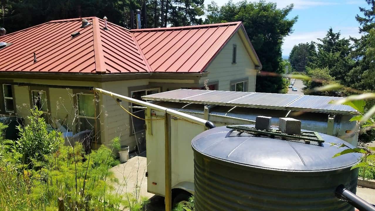 Large rainwater tank outside house