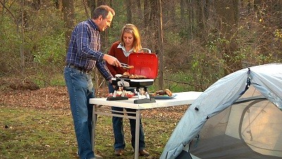 Couple grilling outdoors