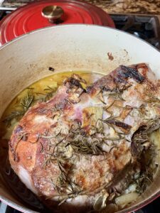 cooked leg of lamb with rosemary in Dutch oven